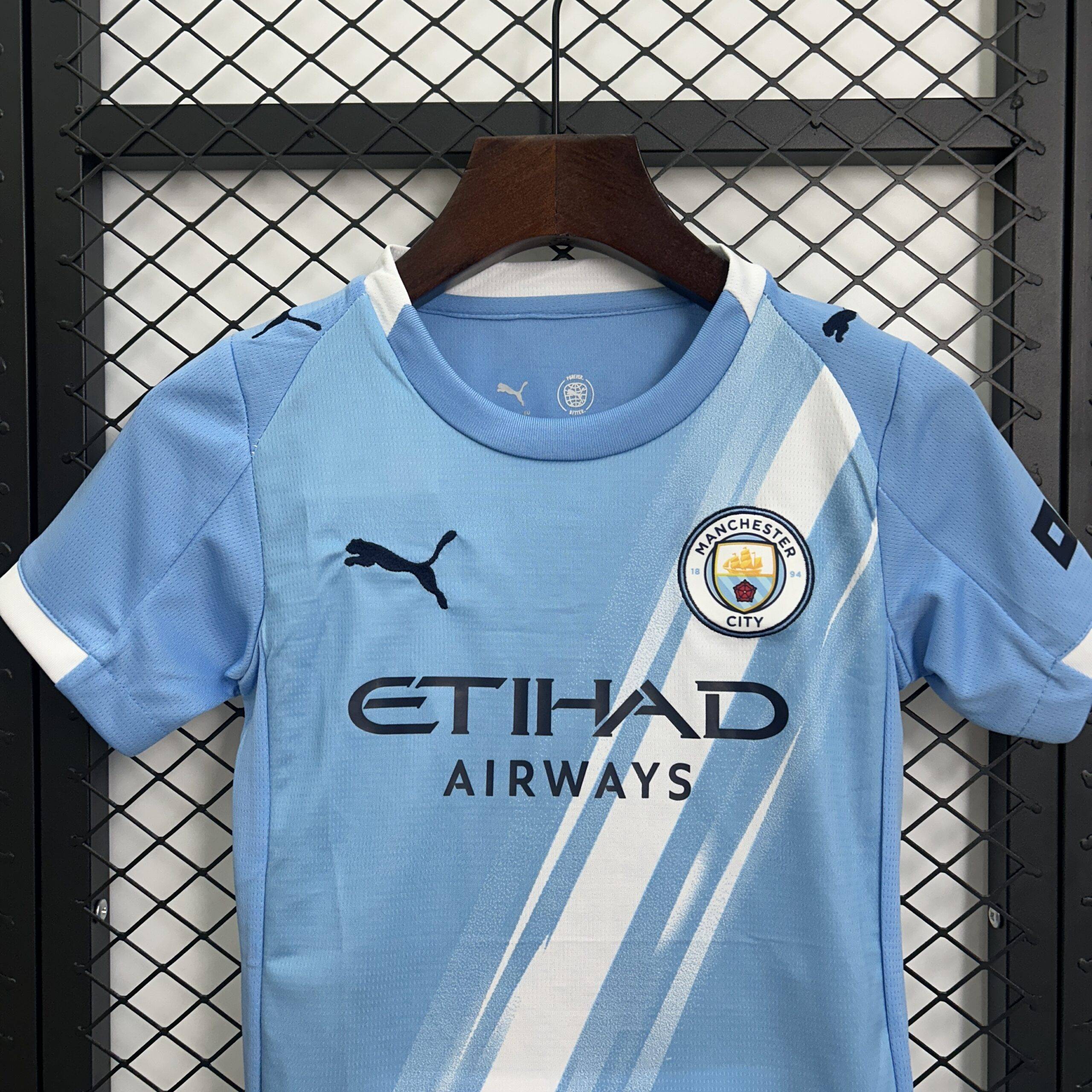 Maglia bambini Manchester City 25/26, taglie 16-28, design blu, ideale per allenamento e partite.